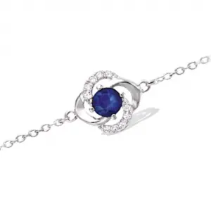 Bracelet en argent rhodié 925 millièmes d'une fleur montée d'une pierre bleu saphir et de strass