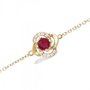 Bracelet plaqué or d'une fleur montée d'une pierre rouge rubis et de strass