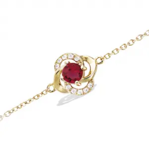 Bracelet plaqué or d'une fleur montée d'une pierre rouge rubis et de strass