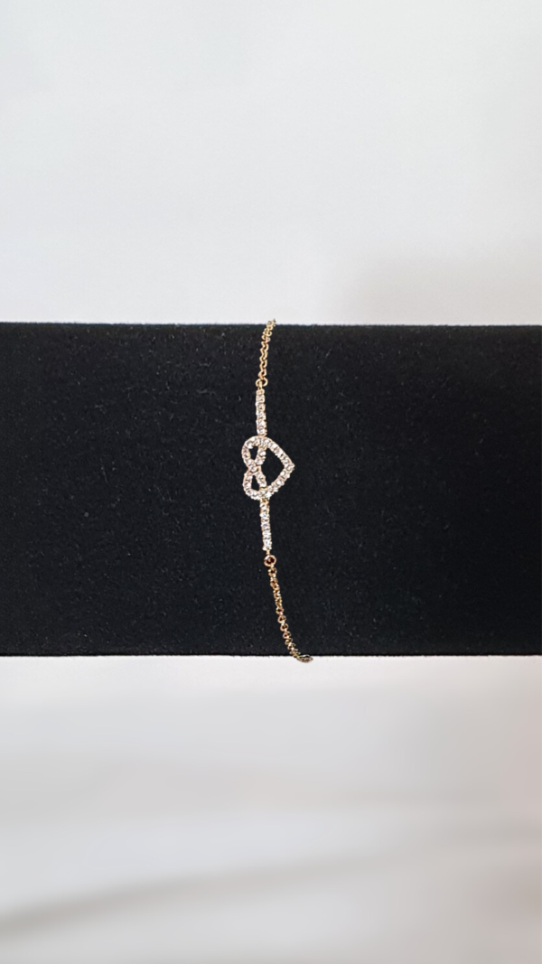Bracelet plaqué or d'un cœur couvert de strass sur présentoir