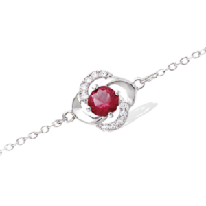 Bracelet en argent rhodié 925 millièmes d'une fleur montée d'une pierre rouge rubis et de strass.