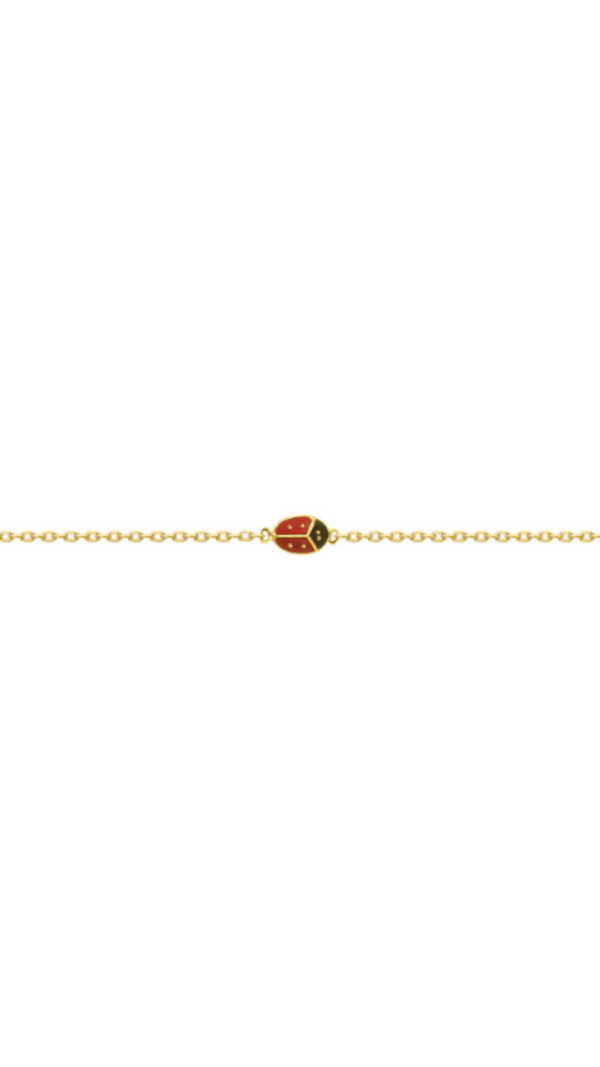 Bracelet plaqué or en forme de coccinelle rouge à pois noirs.